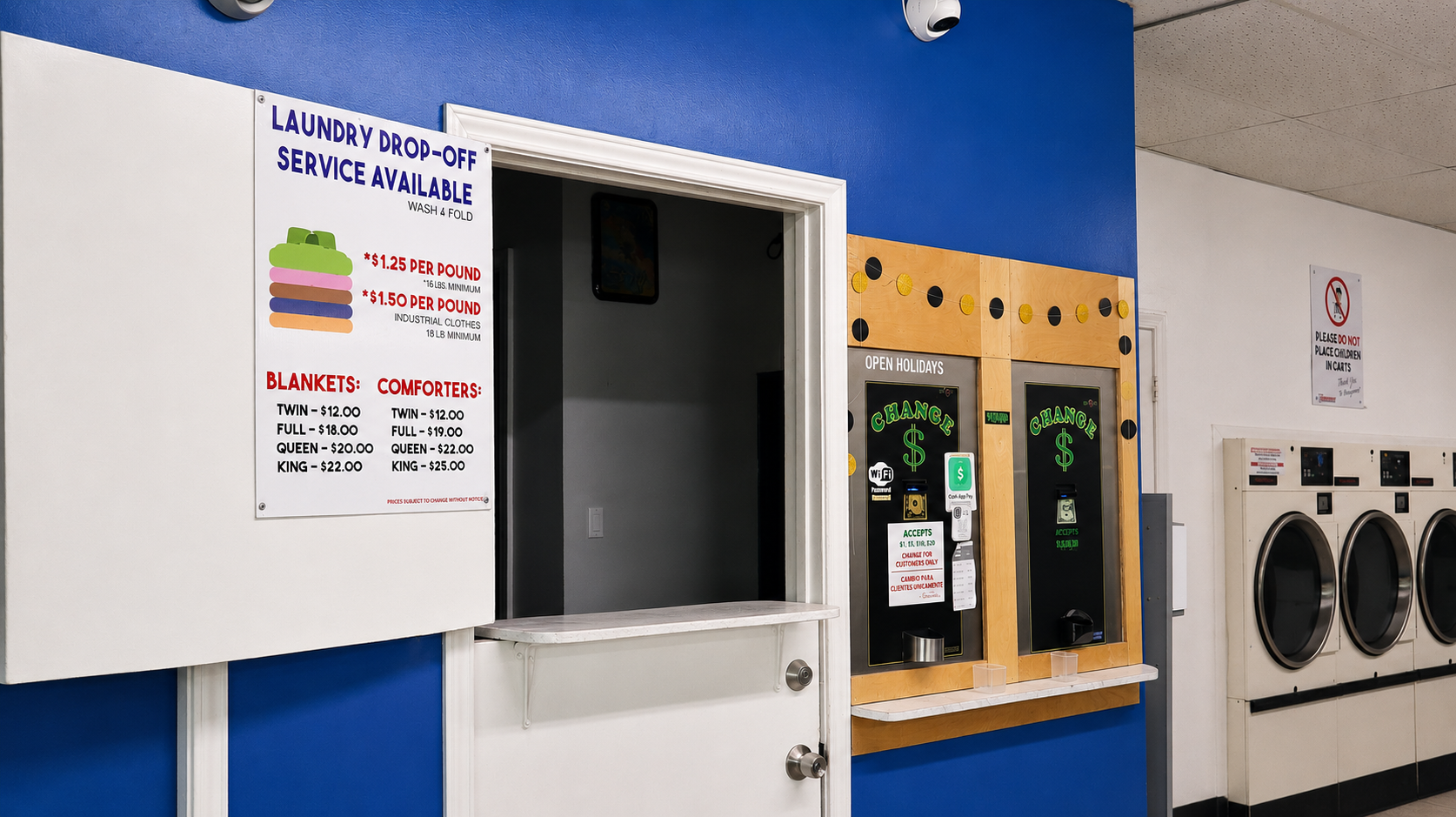 Rudy's Laundromat drop-off pricing sign showing wash & fold rates and blanket and comforter prices